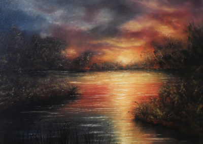 Blush of Nightfall. Colourful oil painting of a lake at sunset. The clouds are blue red and yellow. The colours are reflecting in the water. You can see some bushes and trees on a few islands. Canvas 40x30cm. by Lia van Elffenbrinck